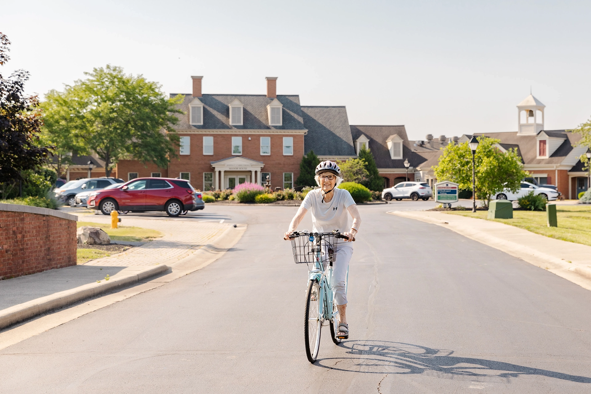 Berkely Square senior living resident riding her bike around the community