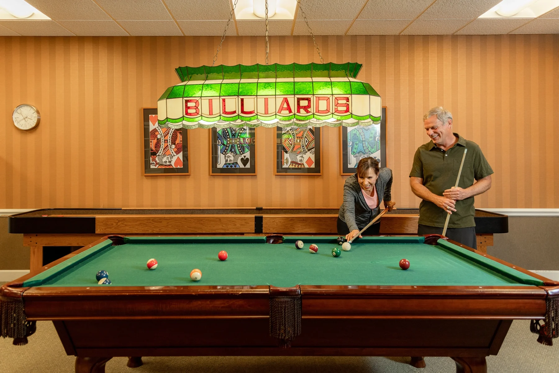 Berkeley Square senior living couple playing billiards in the community room