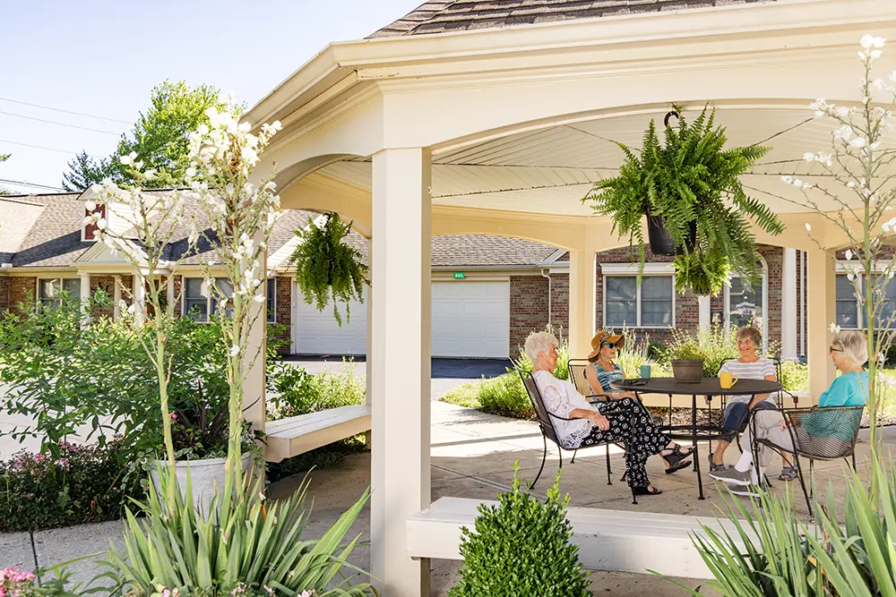 Westover senior living residents chatting outdoors under the gazebo