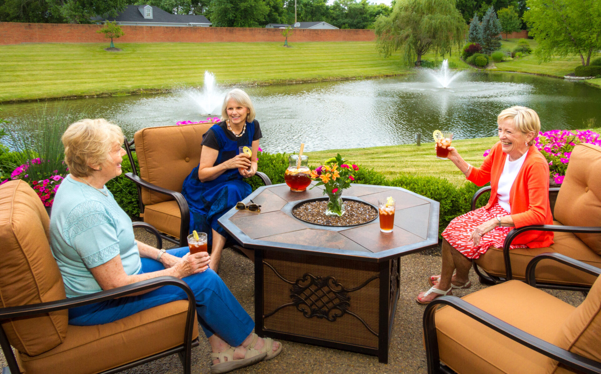 older adults outside enjoying a patio in independent living