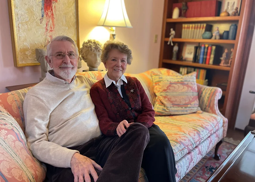 Berkeley Square residents Paul and Marion Thoms sitting together on their couch