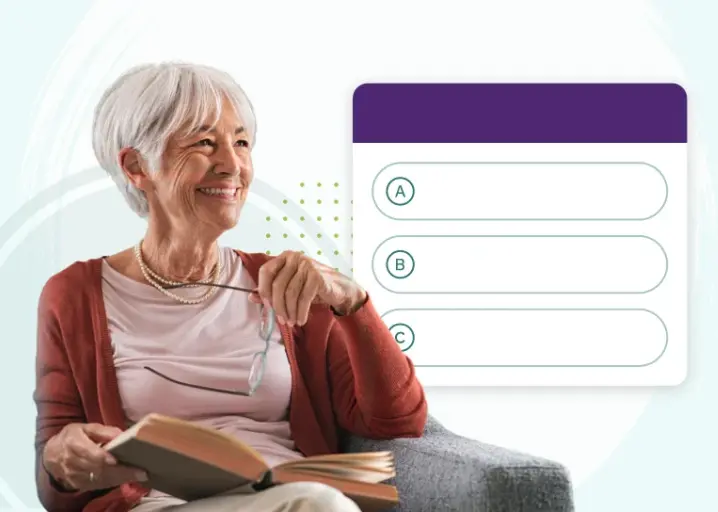 senior holding her eye glasses and book smiling